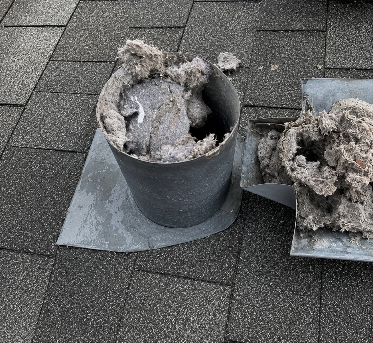 Clogged roof dryer vent cap with lint buildup