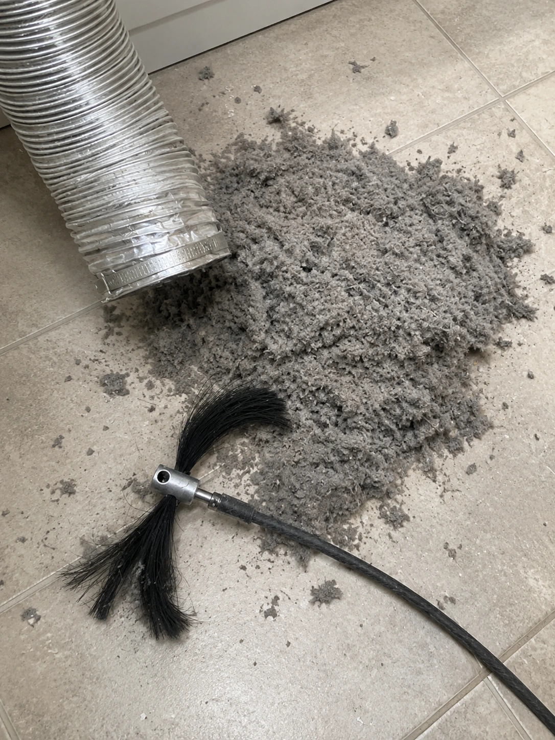 Dryer duct cleaning brush with lint removed from the vent system